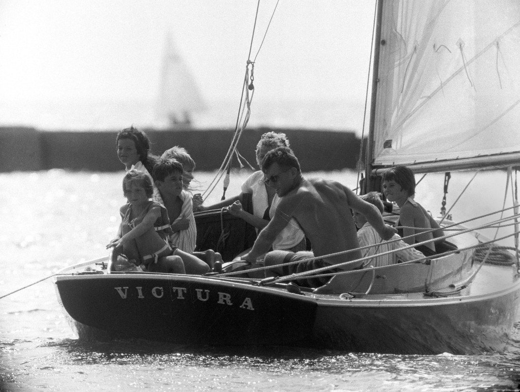 Robert F. Kennedy steers Victura with plenty of helpers. No youngster was turned away, no matter the boat's crew capacity.  From Victura, AP Photo/Bob Schutz, July 30, 1961.