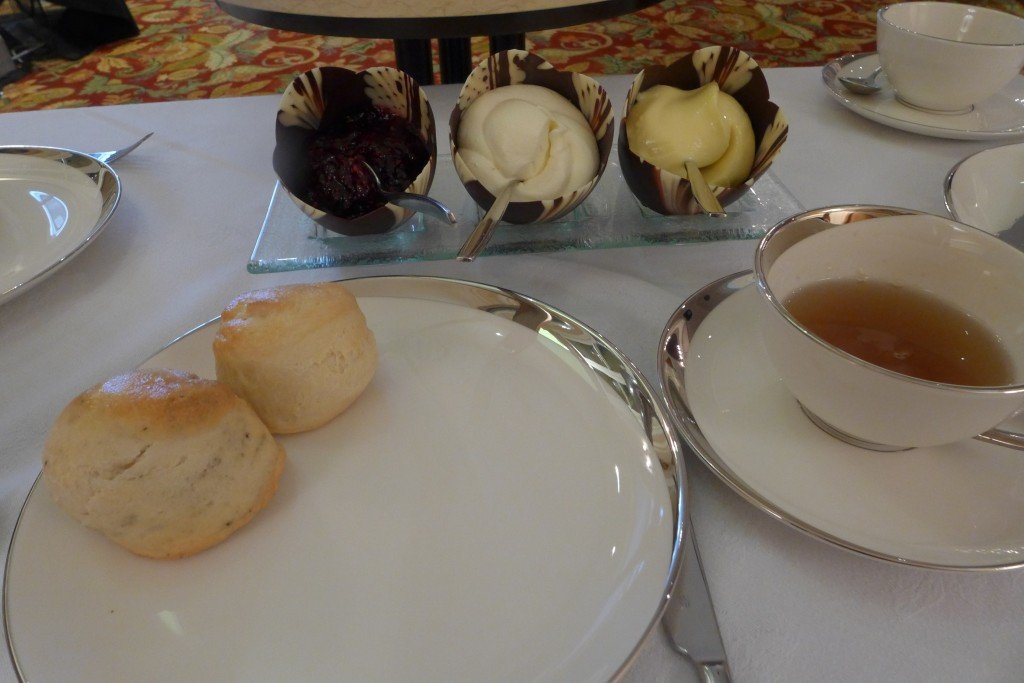 Scones with Devonshire cream, lemon curd, and jam in chocolate shells. 