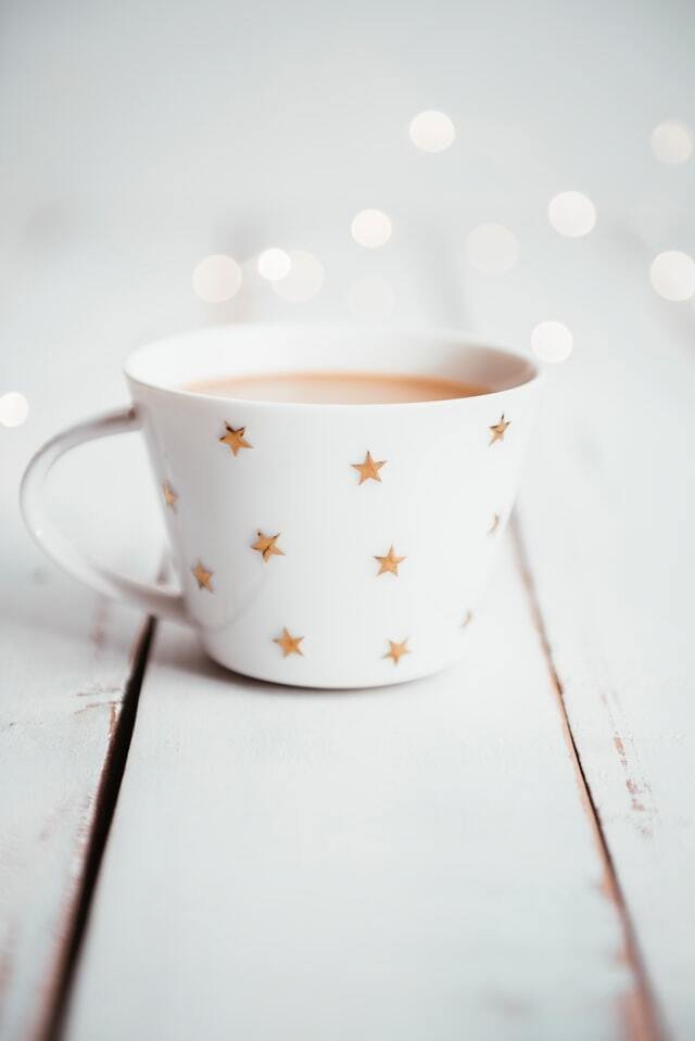 Neutral holiday mug with stars on white background
