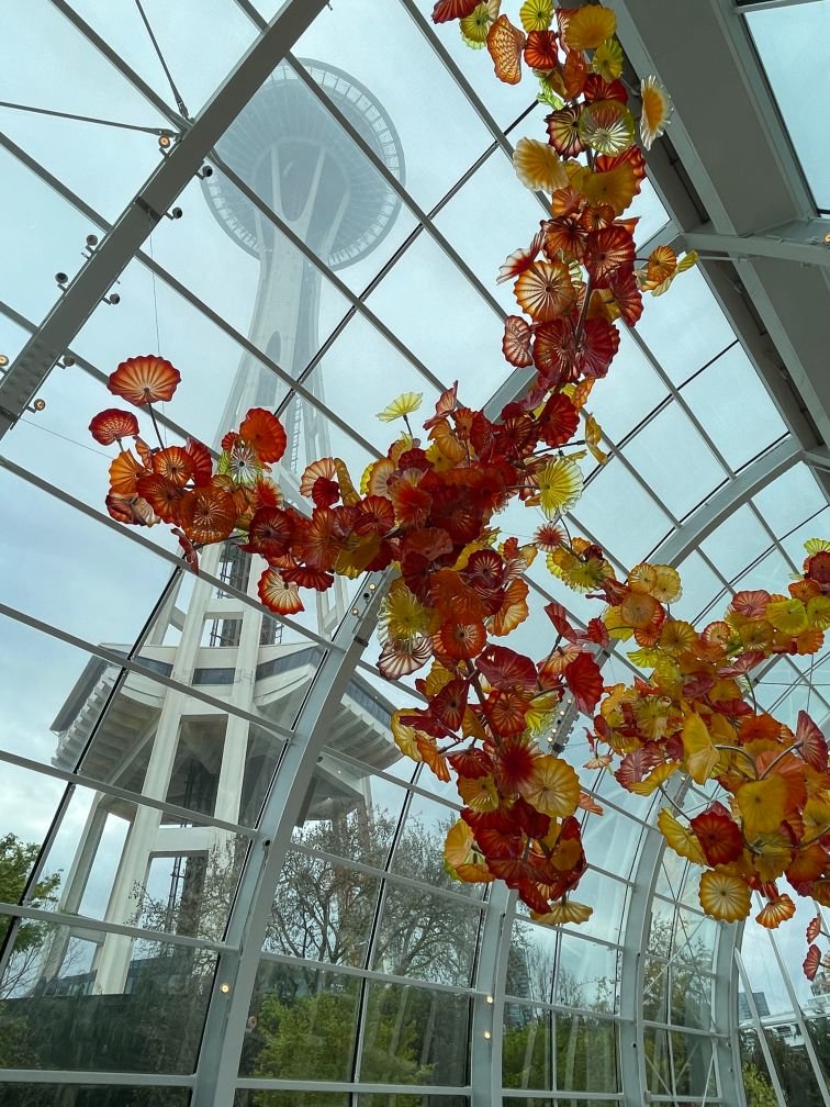 Glasshouse with Space Needle towering above