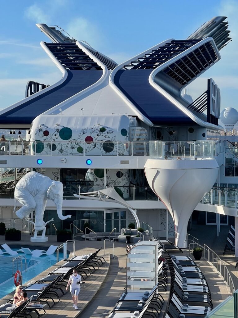 Whimsical elements enliven the Celebrity Beyond, like the sculpture at the main pool of a man balancing an elephant on his back, and the hot tubs perched above the pool in what look like martini glasses. Photo by Terri Colby