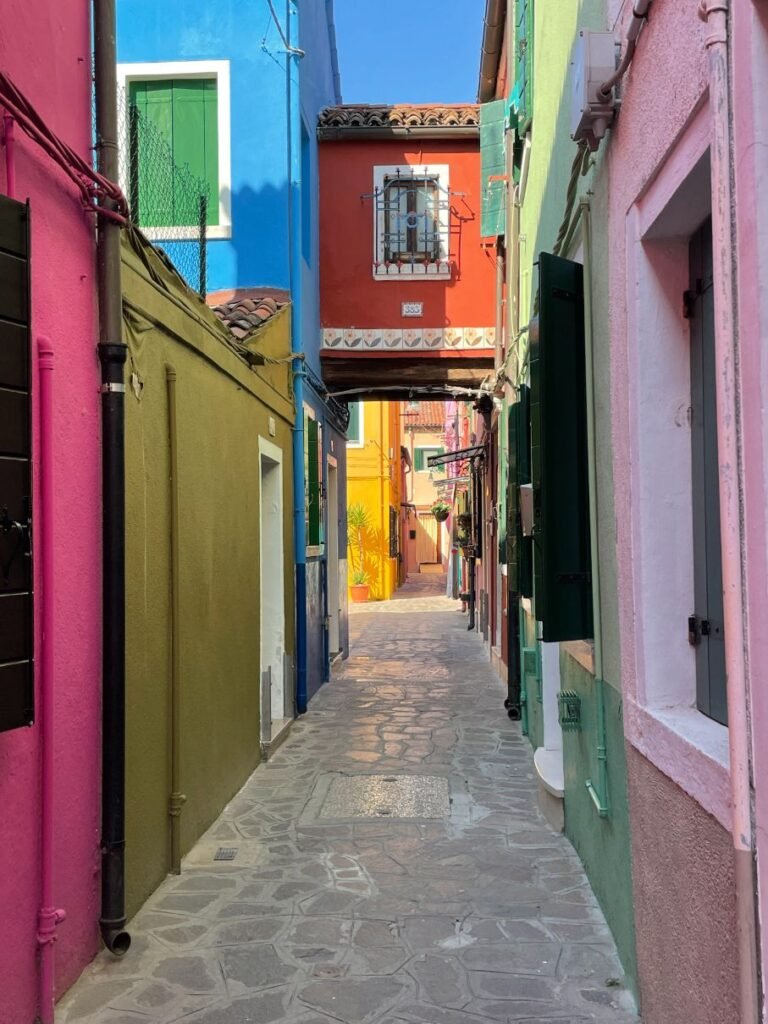 Stroll down the colorful narrow passageways of Burano