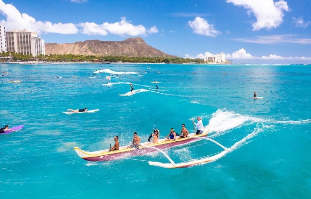 Catch some waves on an outrigger surfing canoe ride at Waikiki Beach