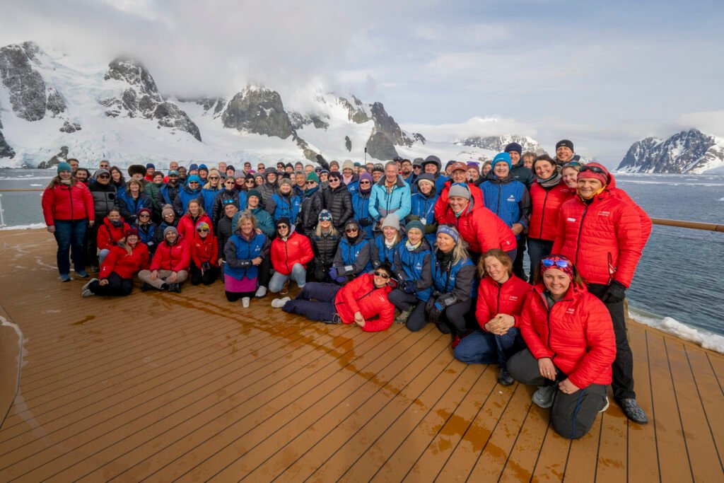 From sharing a life changing experience together new friendships are born. Group photo on the ship's forward deck with expeditioners and Aurora's talented Expedition Team. Photo by Scott Portelli.