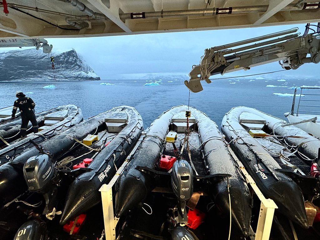 On an expedition ship work is always happening behind the scenes. If it snows overnight, there are crew members who are up early prepping the Zodiacs for the days adventures. Photo by Jett Britnell