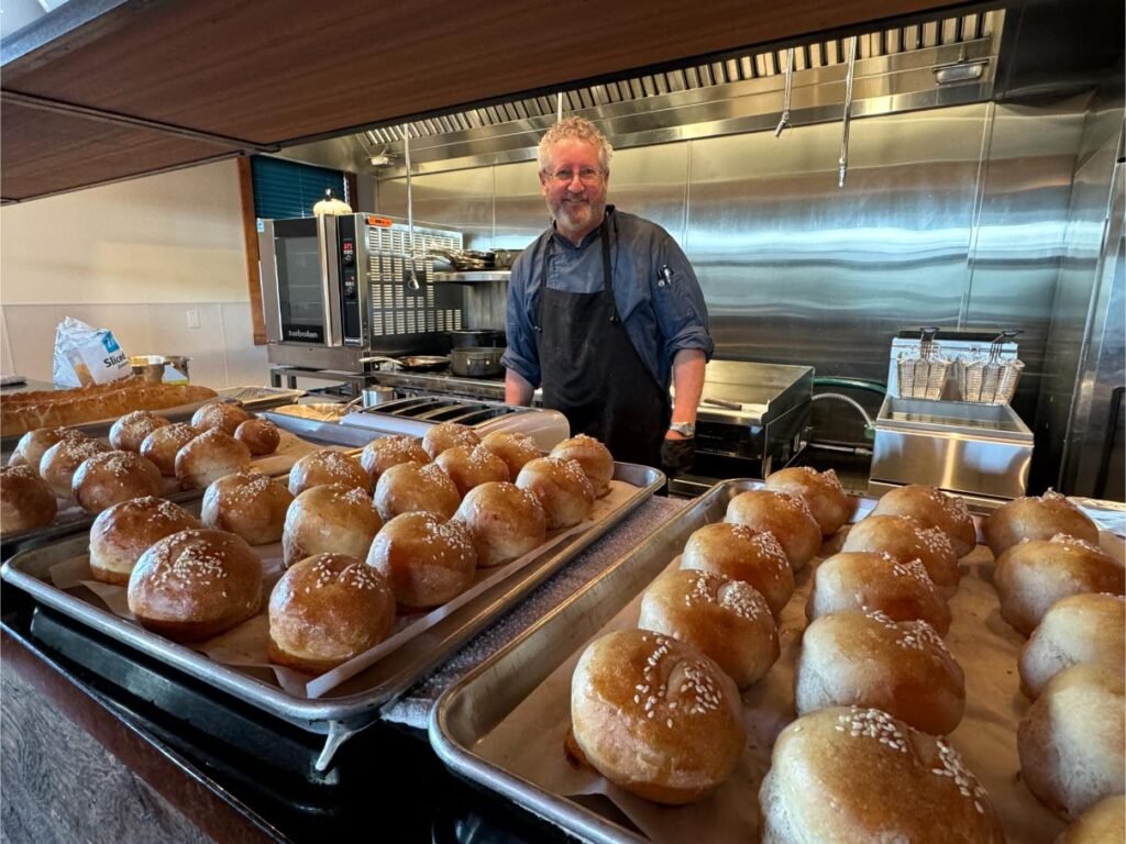 Lake Clark Lodge chef with his freshly baked rolls. Photo by Debbie Stone