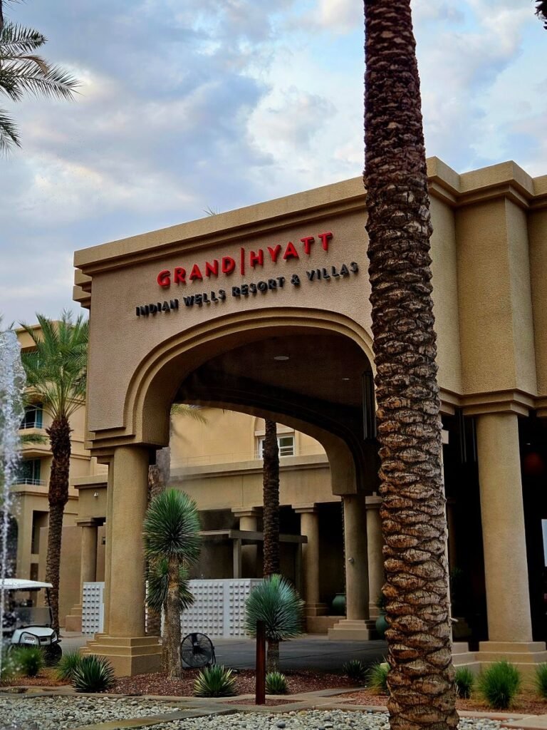 The entrance of Grand Hyatt Indian Wells Resort and Villa with its name above the arch entrance.