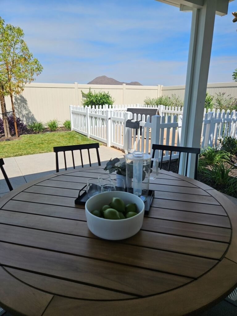 Backyard of home with white picket home designed for dogs.