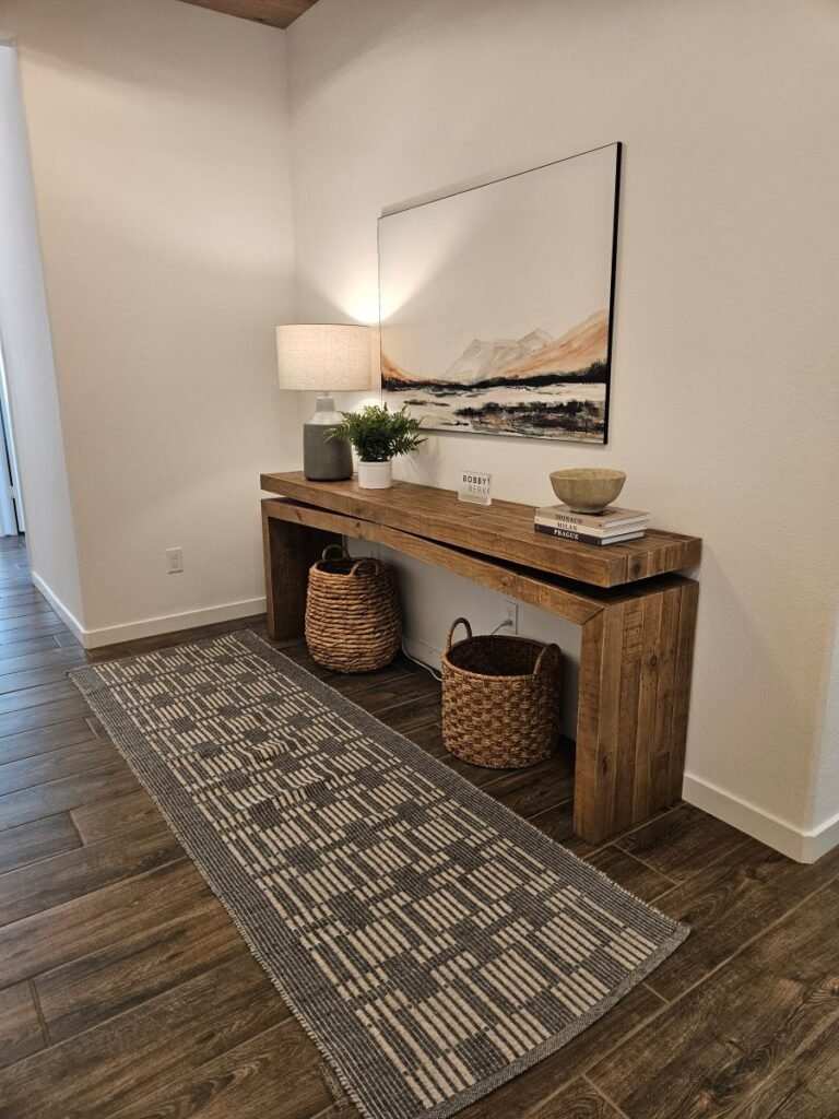 Wood side-table in the entrance of Bobby Berk designed home.