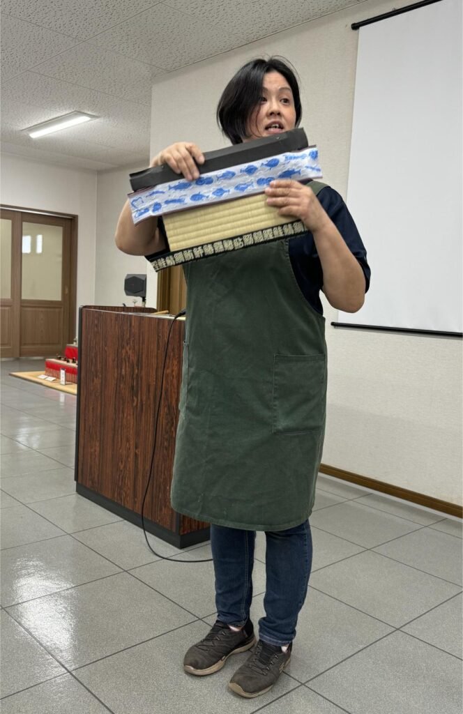 Learning to decorate a tatami mat. Photo by Debbie Stone