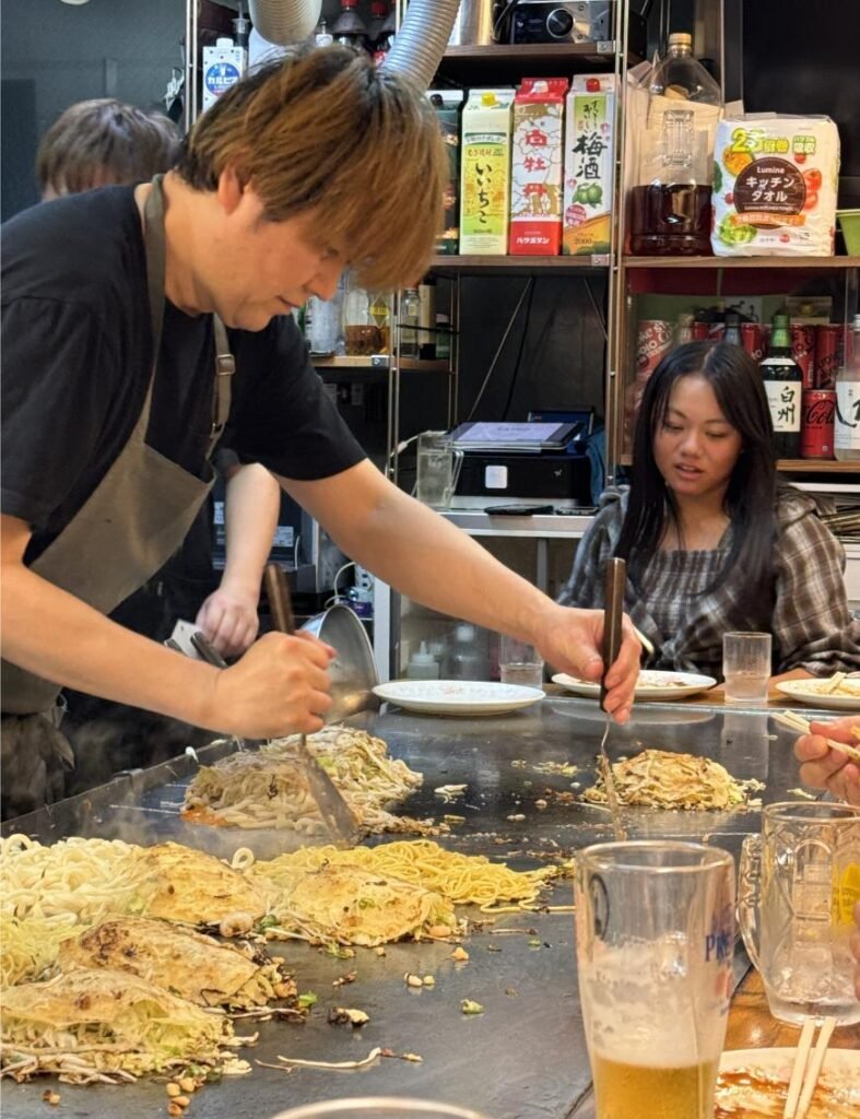 Making okonomiyaki Hiroshima style. Photo by Debbie Stone