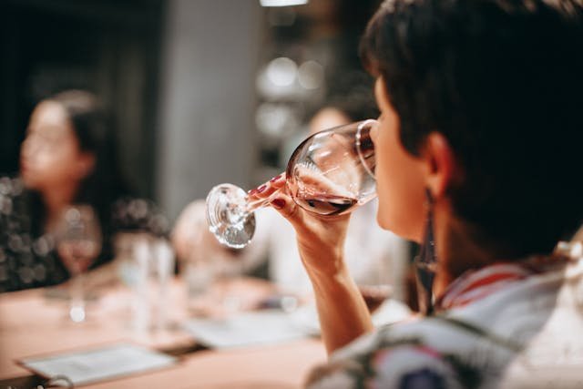 A woman drinking wine with her friends