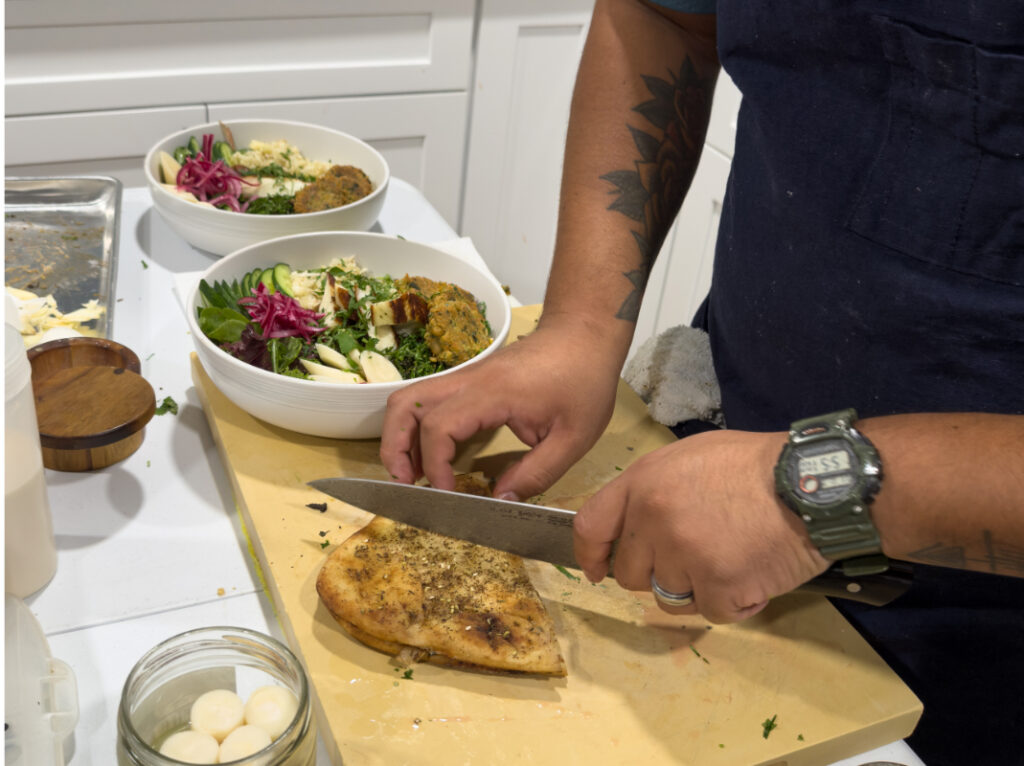 Chef Jonathan slicing the garlic and butter naan for plating