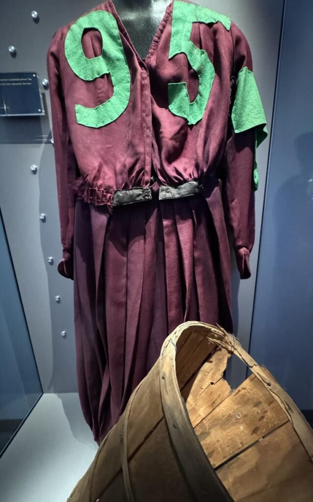 A woman's uniform from 1893 next to a peach basket. Photo by Debbie Stone